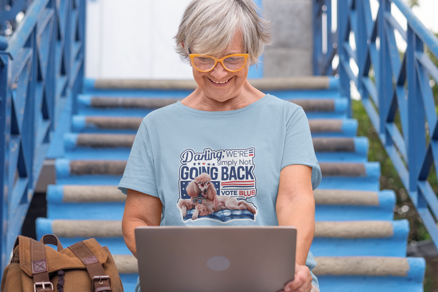 a woman with glasses is using a laptop