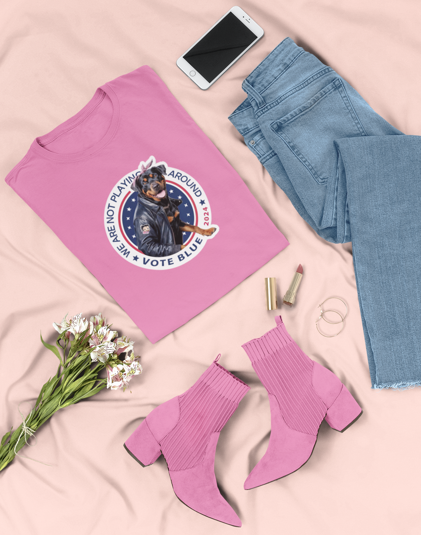 a pink t - shirt with a picture of a dog on it next to a