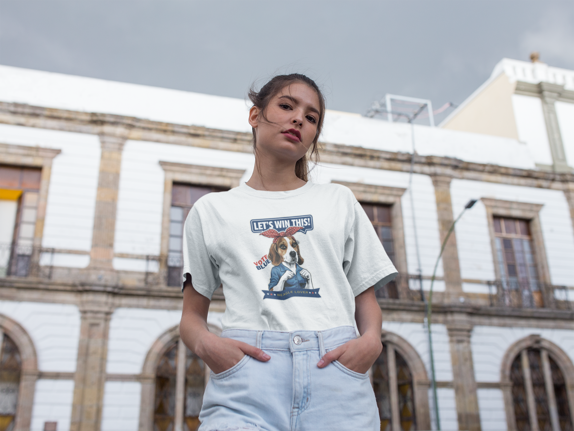 a woman standing in front of a building with her hands in her pockets